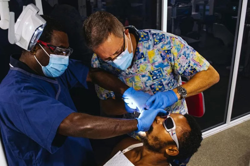 Dentist treating patient